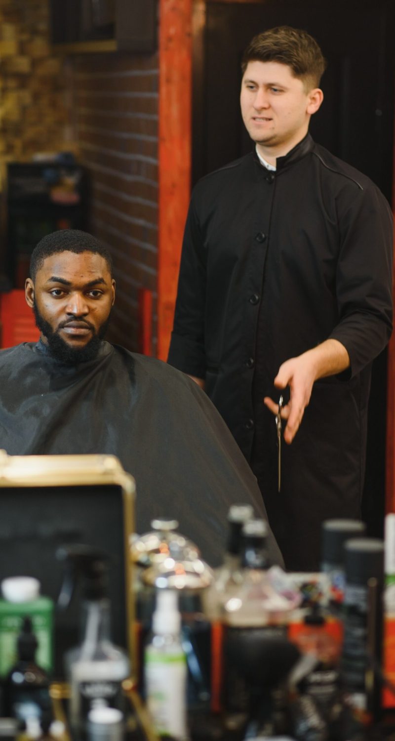 young-african-american-man-visiting-barbershop-AZS4VBB-scaled.jpg